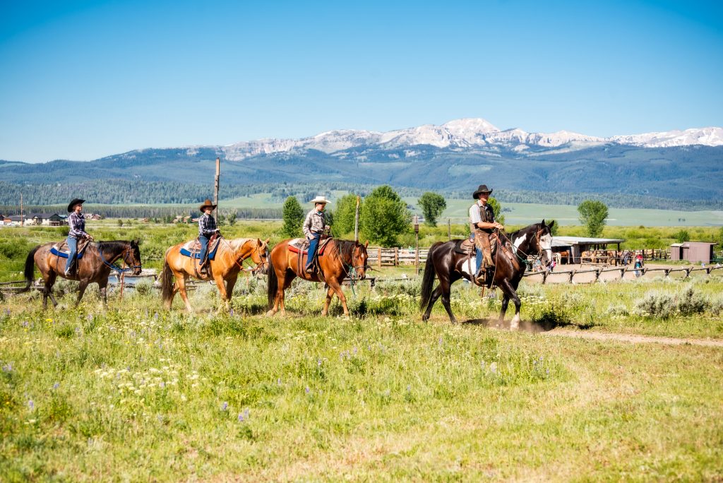 Family Vacationing on Horse Back at Dude Ranch in Montana